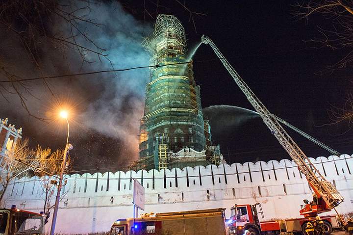 Russian firefighters are at work to extinguish a fire which broke out in Novodevichy Convent bell tower in central Moscow, on March 15, 2015.