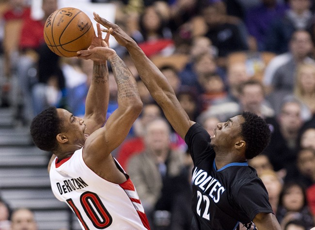 Toronto Raptors' DeMar DeRozan (10) gets fouled by Minnesota Timberwolves' Andrew Wiggins (22) during first half NBA basketball action in Toronto on Wednesday, March 18, 2015. 