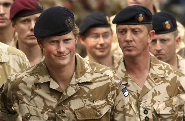 File-This May 5, 2008, file photo shows Britain's Prince Harry, left, arriving for a thanksgiving service at the Army Garrison Church in Windsor, England, after receiving a campaign medal for serving in Afghanistan. 