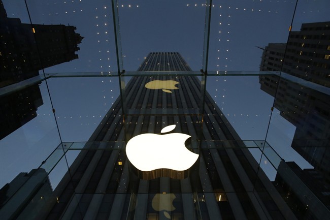 The Apple logo is illuminated in the entrance to the Fifth Avenue Apple store, in New York.