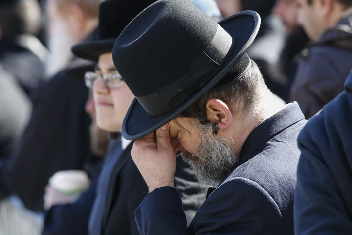 An Orthodox Jewish man grieves during the funeral for seven children that died in a house fire on Mar. 22, 2015 in the Brooklyn borough of New York City. 