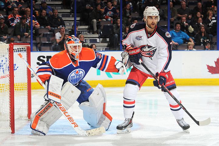 Ben Scrivens #30 of the Edmonton Oilers battles for position against Nick Foligno #71 of the Columbus Blue Jackets on March 18, 2015 at Rexall Place in Edmonton, Alberta, Canada.