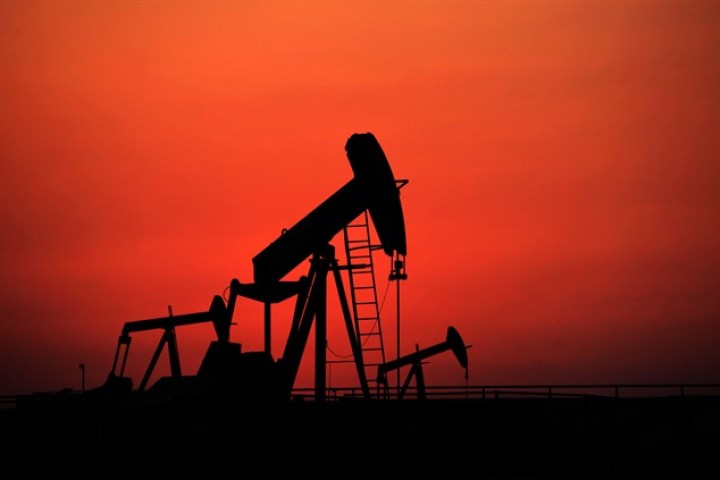 Oil pumps work at sunset on Sept. 11, 2013, in the desert oil fields of Sakhir, Bahrain. THE CANADIAN PRESS/AP, Hasan Jamali