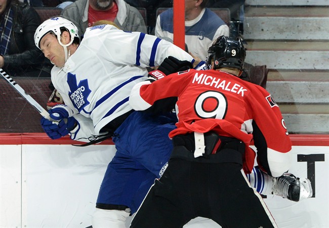 Ottawa Senators' Milan Michalek slams Toronto Maple Leafs' Eric Brewer into the boards during first period NHL hockey action in Ottawa on Saturday, March 21, 2015.