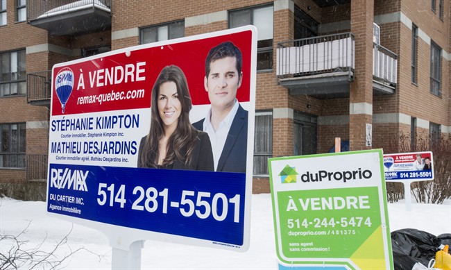 For sale signs are seen in front of a Montreal property.