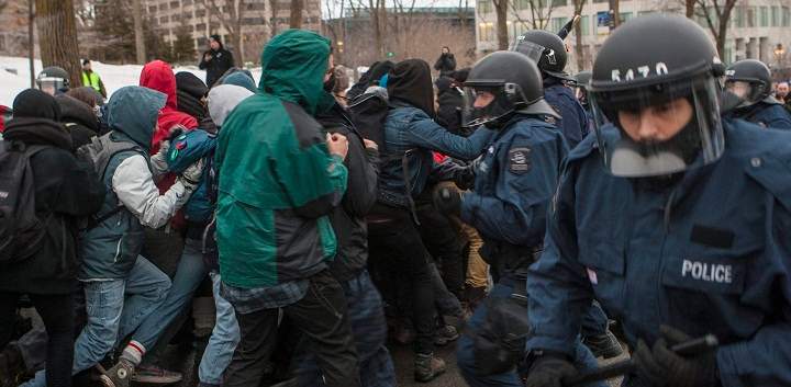 Protesters and police scuffle during a protest against austerity organized by the ASSE student group in Quebec City, Thursday, March 26, 2015.