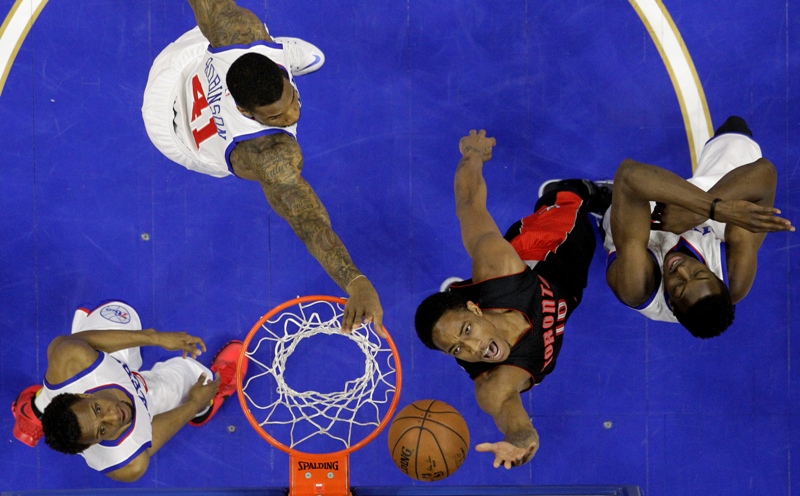 Toronto Raptors' DeMar DeRozan (10) shoots against Philadelphia 76ers' Jerami Grant, from right, Thomas Robinson and Ish Smith during the first half of an NBA basketball game, Monday, March 2, 2015, in Philadelphia. Toronto won 114-103. 