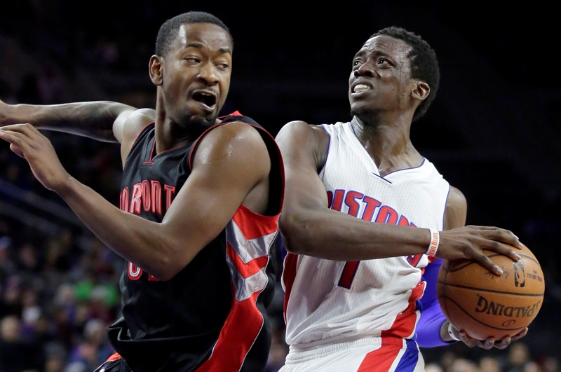 Toronto Raptors' Terrence Ross, left, tries blocking Detroit Pistons' Reggie Jackson (1) from going to the basket during the second half of an NBA basketball game Tuesday, March 24, 2015, in Auburn Hills, Mich. Jackson led the Pistons with 28 points in a 108-104 win.