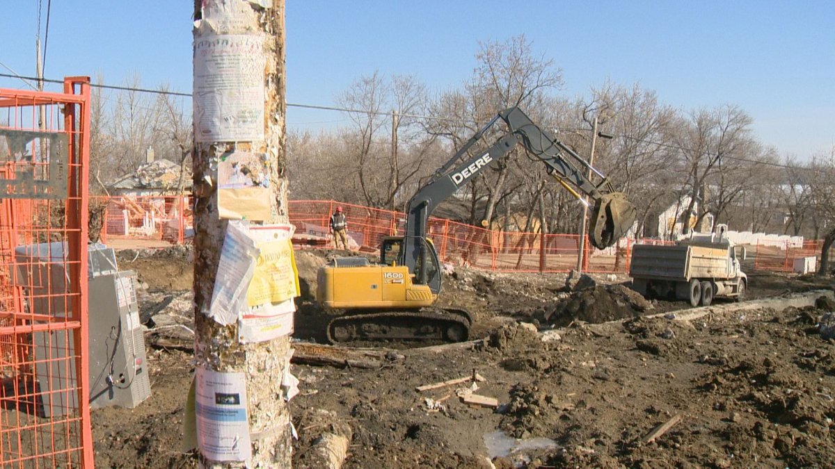 Bulldozer tears apart the foundation of the Oldershaw family cottage, which blew up in a natural gas explosion in December.