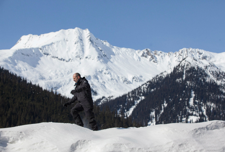 Jeff Goodrich, senior avalanche officer in Glacier National Park walks along the snow banks at Roger Pass, B.C. on Wednesday, March 4, 2015. An abandoned railway line is all that remains at the summit of the Rogers Pass to mark the spot where 58 men lost their lives in what's believed to be Canada's deadliest avalanche around midnight on March 4, 1910. 