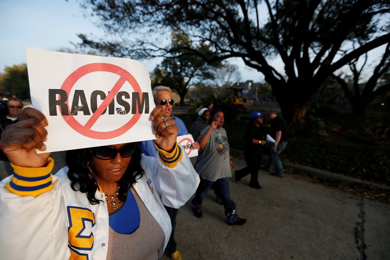Darmita White and about two-dozen others protests outside the family home of a former University of Oklahoma Sigma Alpha Epsilon fraternity member Parker Rice, Wednesday, March 11, 2015, in Dallas. Rice and several other fraternity members were seen on video chanting a racist song. 