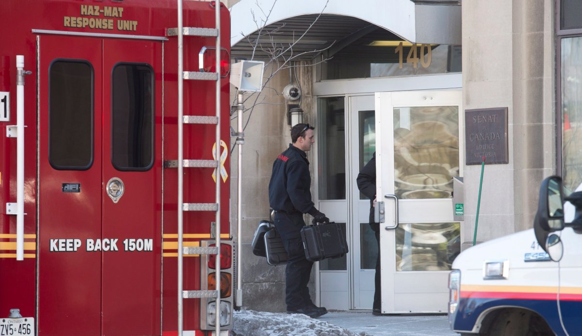 Members of the Ottawa Fire Department hazardous materials team unload equipment outside a Senate building in the Parliamentary precinct in Ottawa, Monday March 23, 2015. Emergency services were investigating a suspicious package. THE CANADIAN PRESS/Adrian Wyld.
