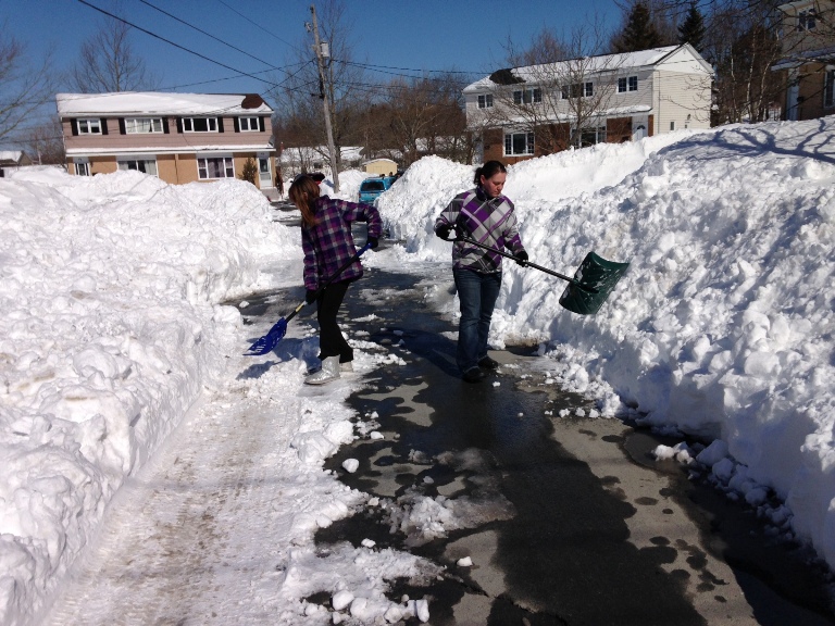 Deanna and Kylie McConnell were just some of the residents who picked up a shovel and dug themselves out of their street.