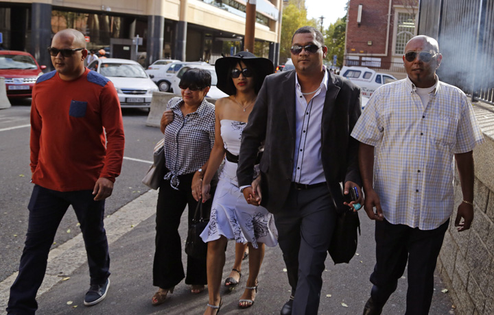 Morne Nurse, second right, the father of a girl that was kidnapped as a baby 17 years ago, and his wife Celeste Nurse, center, arrive at court for the appearance of a woman suspected of the kidnapping in Cape Town, South Africa, Friday, March 6, 2015. 