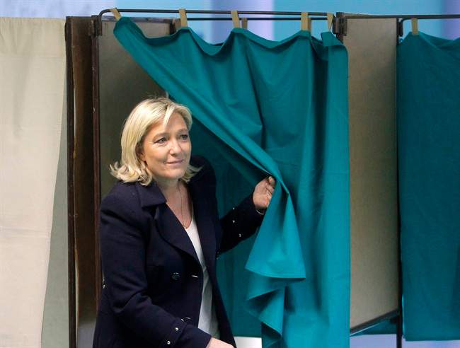 French far-right National Front Party leader, Marine Le Pen, exits from a polling booth after voting in the second round of local elections, Sunday, March 29, 2015, in Henin-Beaumont, northern France.