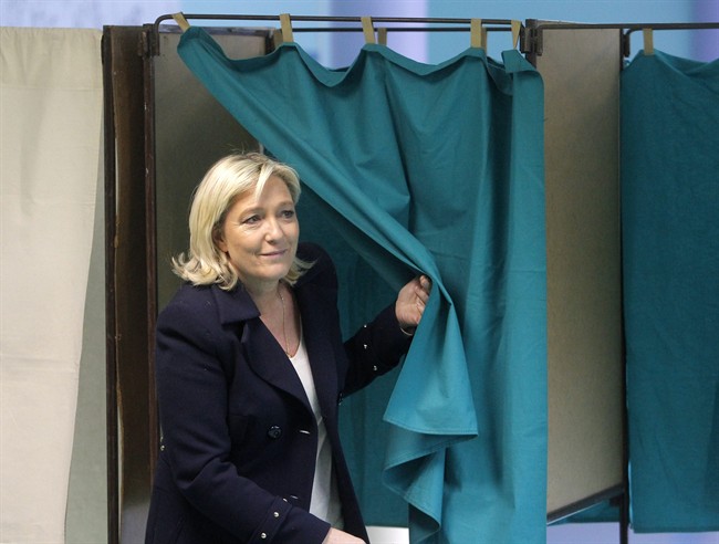 French far-right National Front Party leader, Marine Le Pen, exits from a polling booth after voting in the second round of local elections, Sunday, March 29, 2015, in Henin-Beaumont, northern France.