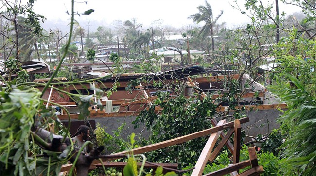 In this photo provided by non-governmental organization 350.org, debris is scattered over a building in Port Vila, Vanuatu.