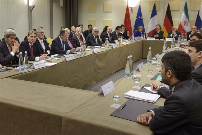 U.S. Secretary of State John Kerry, left, British Foreign Secretary Philip Hammond, second left, Russian Foreign Minister Sergey Lavrov, fourth left, German Foreign Minister Frank Walter Steinmeier. 7th left, French Foreign Minister Laurent Fabius, 8th left, and Chinese Foreign Minister Wang Yi, 9th left wait with others before a meeting on Iran's nuclear program with European Union and Iranian officials at the Beau Rivage Palace Hotel in Lausanne, Switzerland Monday, March 30, 2015.
