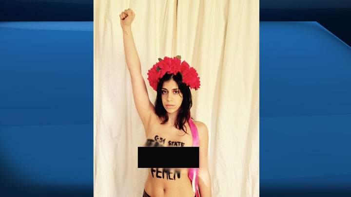Neda Topaloski, above, was removed from the House of Commons Monday, Mar. 23, 2015, while staging a protest, topless, against Bill C-51.