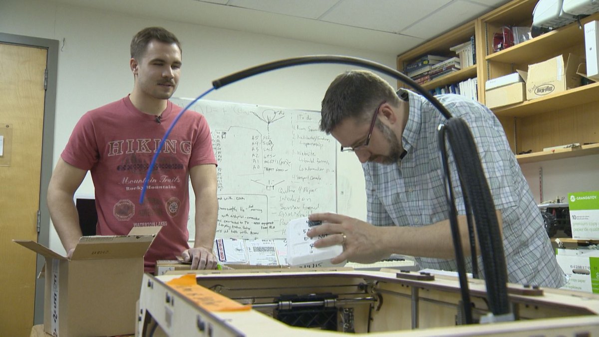William Ogilvie (right) and his partner work on their national high altitude balloon experiment to study the atmosphere.
