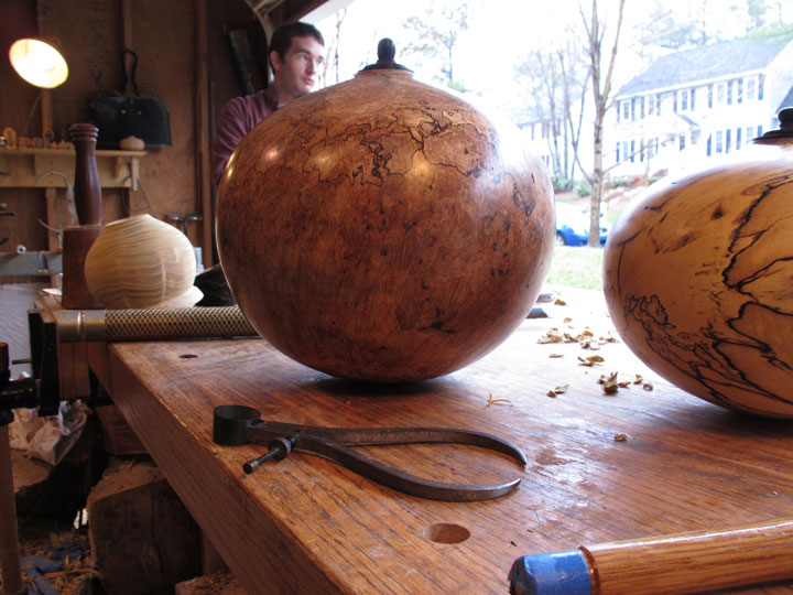 In this March 4, 2015 photo, two of Jason Van Duyn's finished funerary urns sit on a work bench in his Raleigh, N.C., studio. He is one of about two dozen artists who've entered pieces in next month's urn show at Raleigh's historic Oakwood Cemetery.