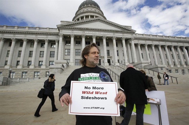 FILE - In this Jan. 27, 2015, file photo, Randy Gardner of Salt Lake City, the older brother of Ronnie Lee Gardner, the last inmate to be killed by firing squad in Utah in 2010, protests with a group opposed to capital punishment plans over one lawmaker's plan to resurrect the use of firing squads, outside the Utah State Capitol, in Salt Lake City.