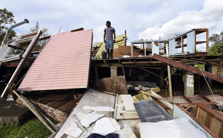 Adrian Banga surveys his destroyed house in Port Vila, Vanuatu in the aftermath of Cyclone Pam, Monday, March 16, 2015.