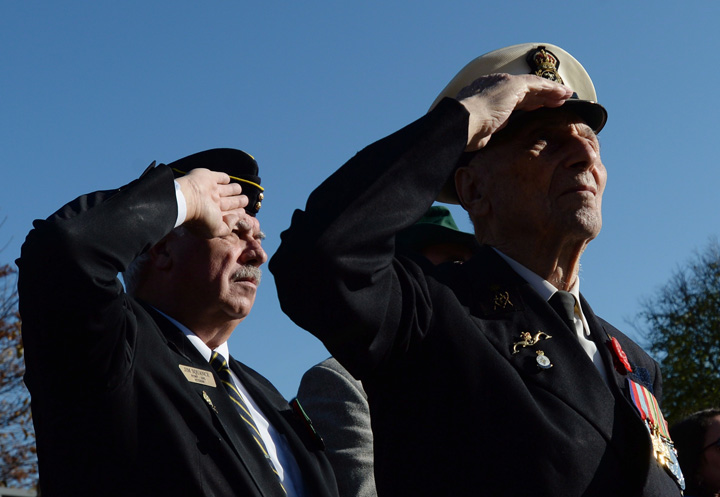 Second World War veteran George Squance, 94, right, of Ottawa salutes alongside fellow veterans during Remembrance Day ceremonies at the National War Memorial in Ottawa on Tuesday, November 11, 2014. The feds are proposing a new retirement benefit for wounded troops, beginning at age 65.