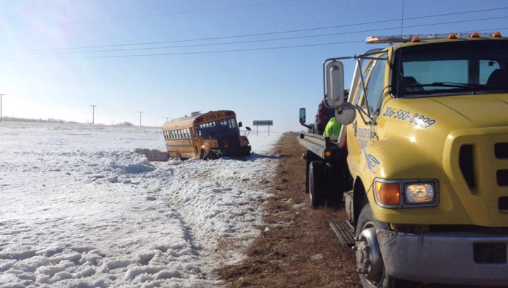 Students taken to hospital with minor injuries, one with a broken collar bone, after a school bus rolls on icy Saskatchewan highway.