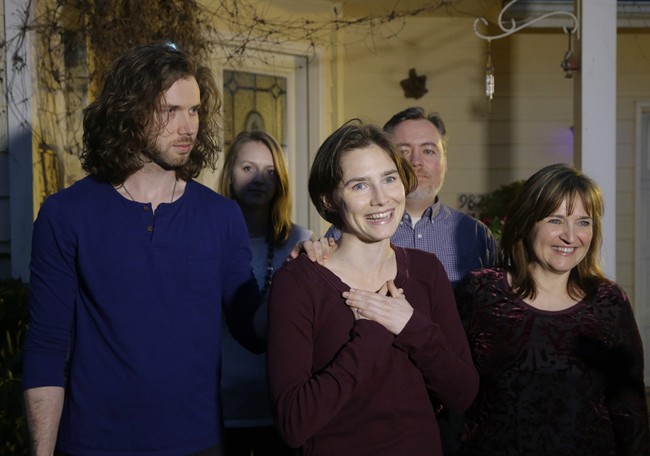 Amanda Knox, center, stands with her mother, Edda Mellas, right, and her fiance, Colin Sutherland, left.