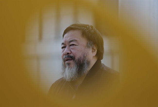 Chinese dissident artist Ai Weiwei speaks during an interview near a playground outside a shopping mall in Beijing Tuesday, March 24, 2015.