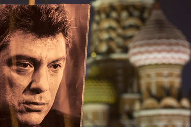 A portrait of Boris Nemtsov, a charismatic Russian opposition leader and sharp critic of President Vladimir Putin, who was gunned down in late February near the Kremlin, seen with St. Basil's Cathedral is in the background in Moscow, Russia, Monday, March 2, 2015.