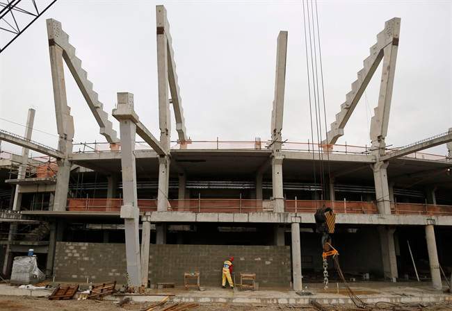 A man works on the Tennis venue at the Olympic Park for the 2016 Olympics in Rio de Janeiro, Brazil, Monday, March 23, 2015. The head of Rio de Janeiro's Olympic organizing committee Carlos Nuzman said Rio would emerge from the games more changed than 1992 host Barcelona or 1964's Tokyo. 