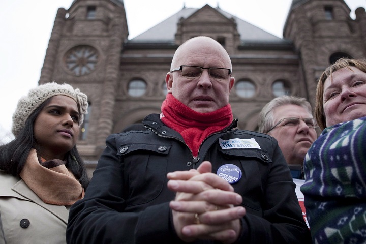 Sid Ryan of the Ontario Federation of Labour pauses before speaking to protesters gathered outside the Ontario Legislature in Toronto on Saturday April 21, 2012. 