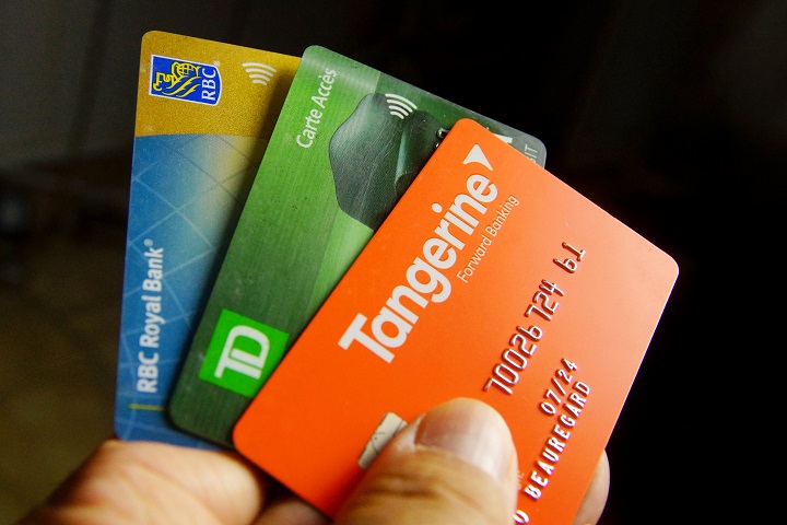 Close-up of a hand holding bank client cards.