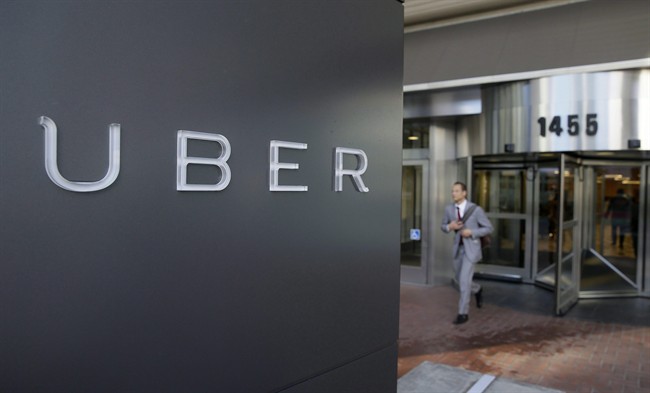 A man leaves the headquarters of Uber in San Francisco in a Dec.16, 2014 file photo. The strong-arm tactics that some Canadian cities have been using against virtual ridesharing company Uber have prompted the organization to try to mend fences with local officials even as it maintains hope for further expansion. 