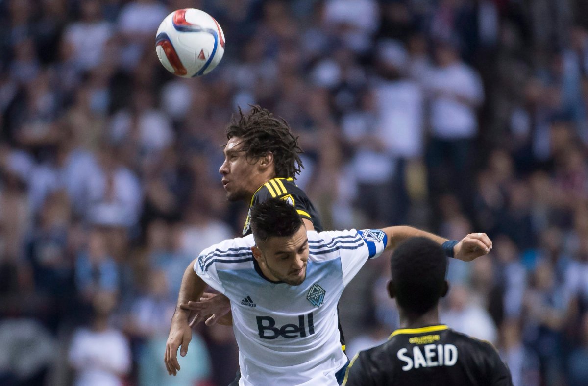 Vancouver Whitecaps FC Pedro Morales fights for control of the ball with Columbus Crew SC Chris Klute during the second half of MLS soccer action in Vancouver, B.C. Wednesday, April, 8, .