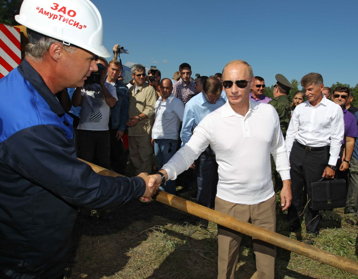 Russia's Prime Minister Vladimir Putin shakes hands with a worker during a visit on the site of Russia's National Space Centre Vostochny  on August 28, 2010.
