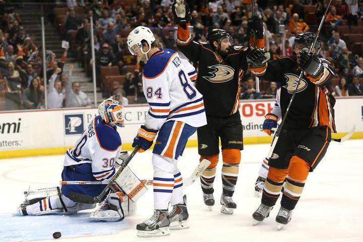 Francois Beauchemin #23 and Nate Thompson #44 of the Anaheim Ducks celebrate after Beauchemin's first period goal gets by goalie Ben Scrivens #30 of the Edmonton Oilers for a first period goal at Honda Center on April 1, 2015 in Anaheim, California.
