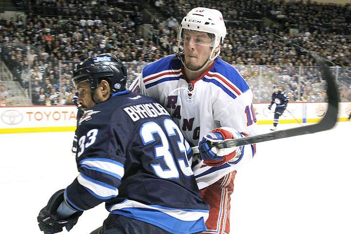  J.T. Miller #10 of the New York Rangers battles Dustin Byfuglien #33 of the Winnipeg Jets as they keep an eye on the play during third period action on Tuesday at the MTS Centre. The NHL Department of Player Safety is looking into an earlier crosscheck by Byfuglien.