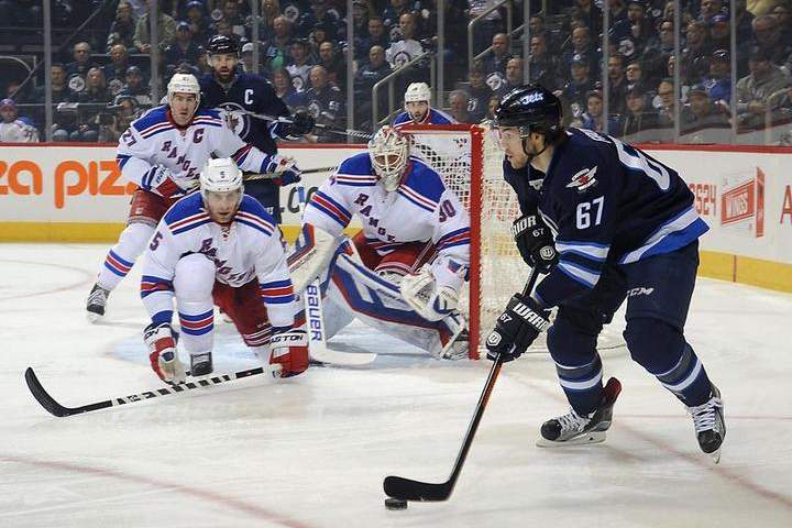 Dan Girardi #5 and goaltender Henrik Lundqvist #30 of the New York Rangers guard the net as Michael Frolik #67 of the Winnipeg Jets plays the puck on Tuesday at the MTS Centre in Winnipeg.