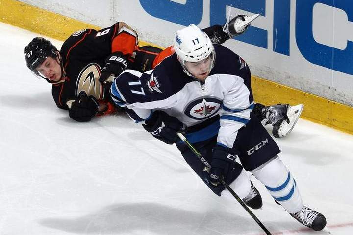 Adam Lowry #17 of the Winnipeg Jets skates away from Rickard Rakell #67 of the Anaheim Ducks during the third period in Game One of the Western Conference Quarterfinals during the 2015 NHL Stanley Cup Playoffs at Honda Center on April 16, 2015 in Anaheim, Calif.
