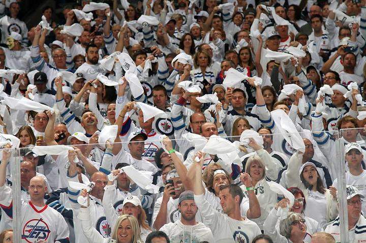Fans cheer and wave white towels as part of the 'Whiteout' prior to puck drop between the Winnipeg Jets and the Anaheim Ducks in Game Four of the Western Conference Quarterfinals.