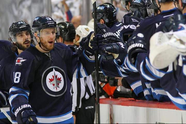 Bryan Little of the Winnipeg Jets celebrates his first period goal against the Anaheim Ducks with teammates at the bench in Game Four of the Western Conference Quarterfinals.