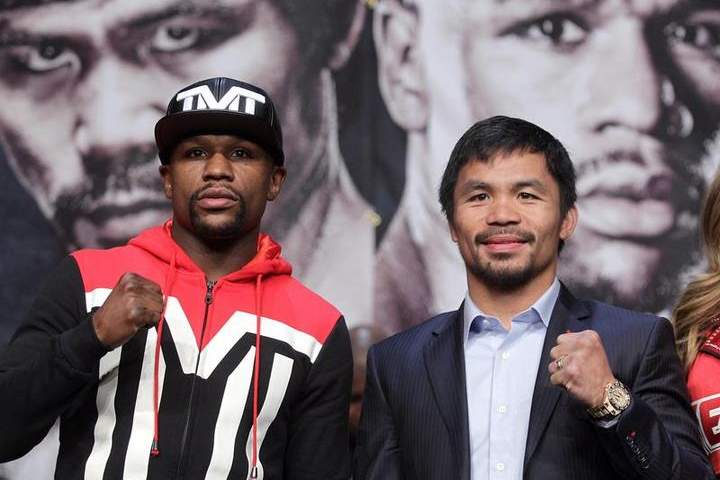 WBC/WBA welterweight champion Floyd Mayweather Jr. (L) and WBO welterweight champion Manny Pacquiao pose during a news conference at the KA Theatre at MGM Grand Hotel and Casino on April 29, 2015.
