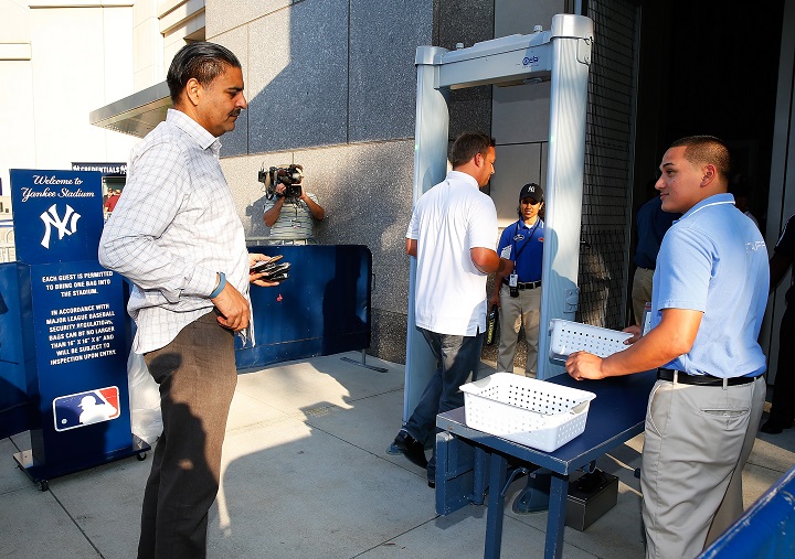 Fans walk through a newly installed metal detector at Gate 2 prior to the game between the New York Yankees and the Houston Astros at Yankee Stadium on August 19, 2014 in the Bronx borough of New York City. 