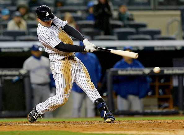 Chase Headley #12 of the New York Yankees hits an RBI single in the 8th inning against the Toronto Blue Jays on April 8, 2015 at Yankee Stadium in the Bronx borough of New York City.