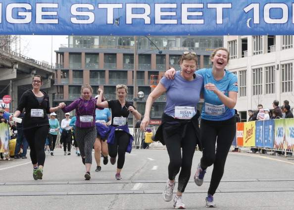 Alexandra McRobert and her mother Susan Humphrey cross the finish line of the Yonge Street 10k run at Fort York Blvd Sunday morning. Toronto, April 13, 2014.  