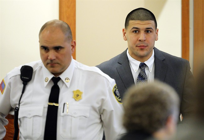 Former New England Patriots NFL football player Aaron Hernandez is led into the courtroom for his murder trial, Wednesday, April 1, 2015, at Bristol County Superior Court in Fall River, Mass. Hernandez is accused of killing Odin Lloyd in June 2013. (AP Photo/Brian Snyder, Pool)