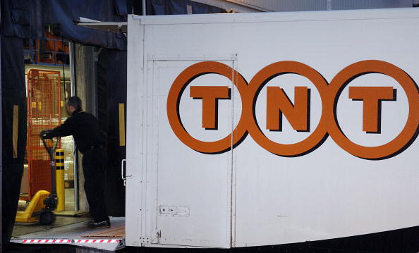 A TNT employee unloads parcels from a truck at the TNT Express distribution depot in Brussels, Belgium, Tuesday, December 6, 2005. 